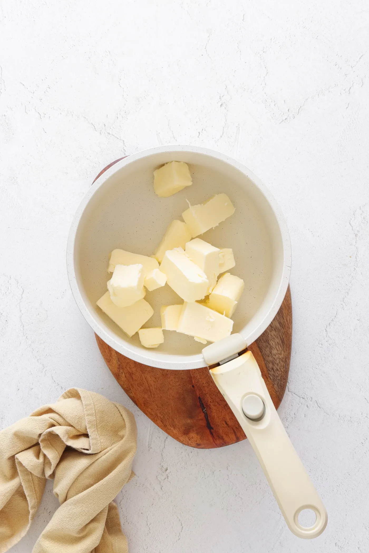 Cubed butter melting in a small saucepan
